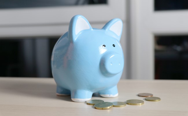 A blue piggy bank on a table, representing salary expectations.